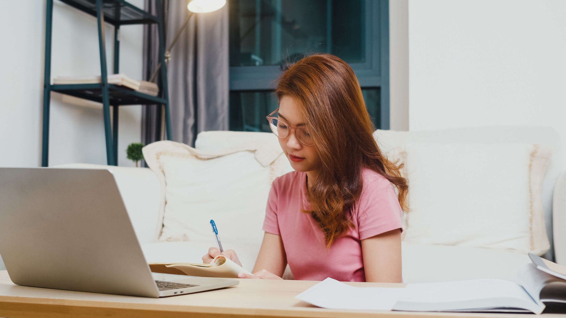 young-asia-teen-girl-student-distance-learning-lesson-with-online-teacher-study-computer-laptop-living-room-from-home-night-social-distancing-quarantine-corona-virus-prevention